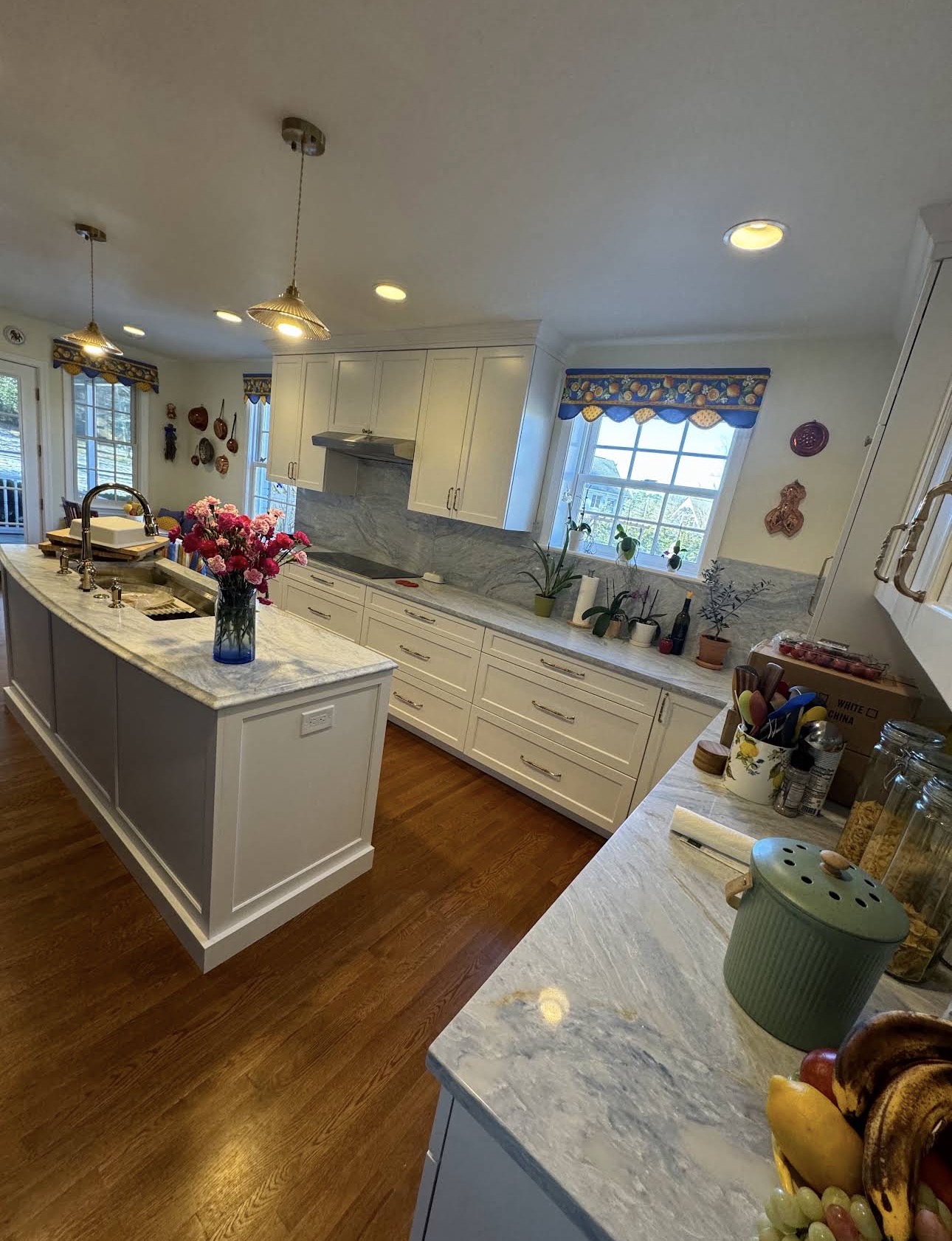 White cabinetry, island, and stone-look surfaces